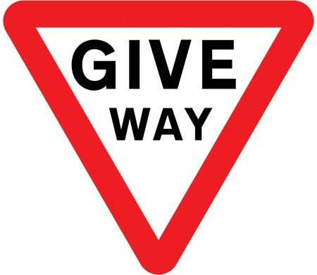 A white triangle pointing down, with a red border and the words GIVE WAY