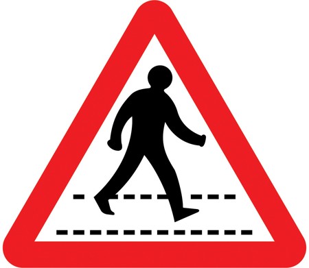 A white triangle with a red border showing a person walking over a crossing