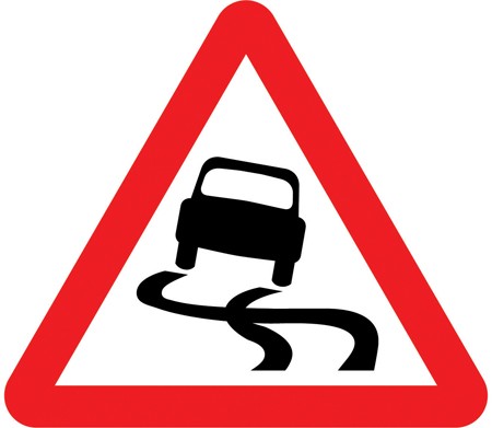 A white triangle with a red border and a black car with skid marks behind it