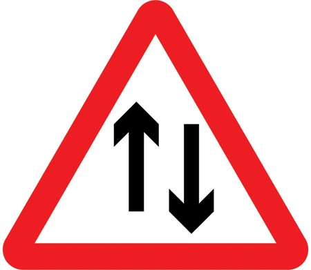 A white triangle with a red border and two black arrows, one pointing up and one down